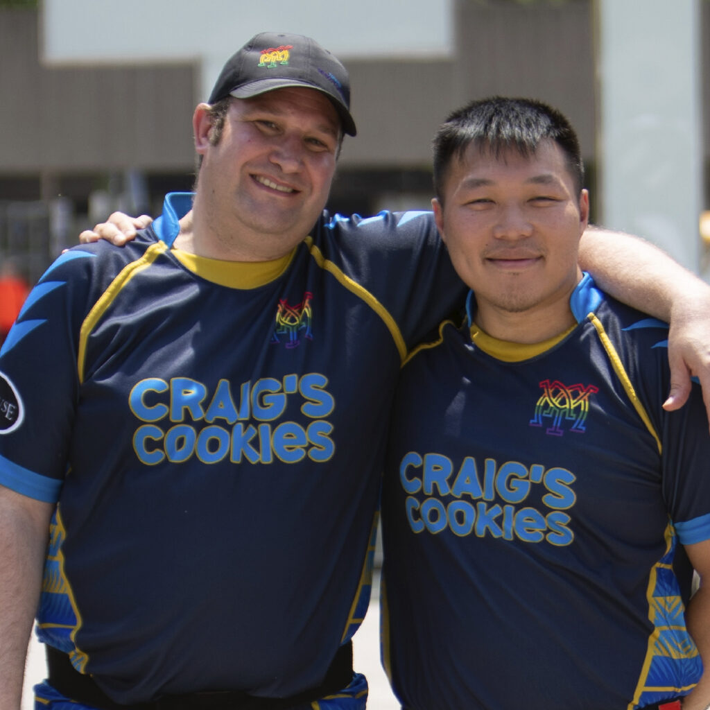 Two Muddy York teammates smiling for the camera at Rugby in the Square.